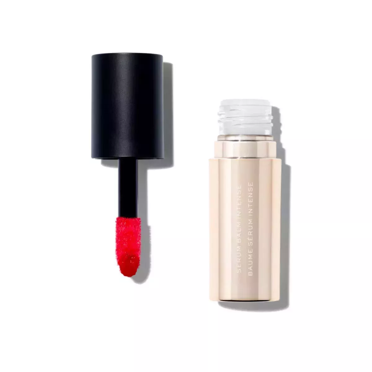A gold and black lip gloss with a red tint