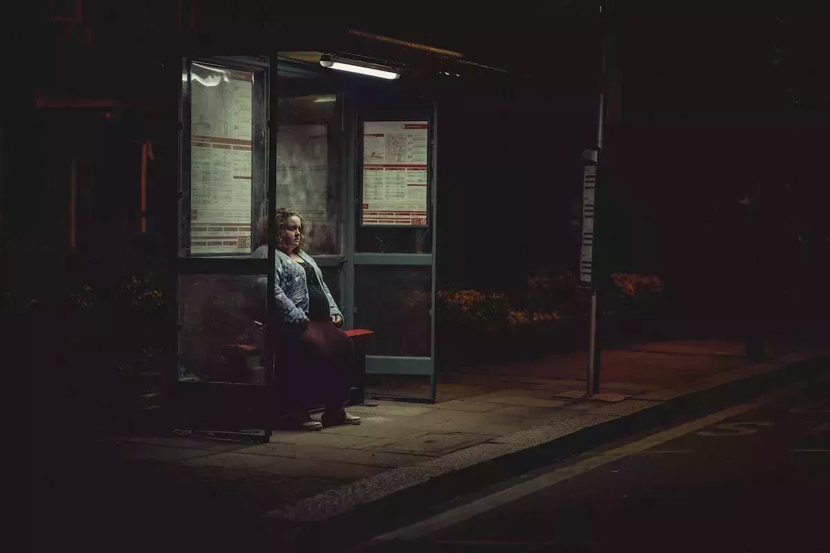 Martha sits at a bus stop in Baby Reindeer
