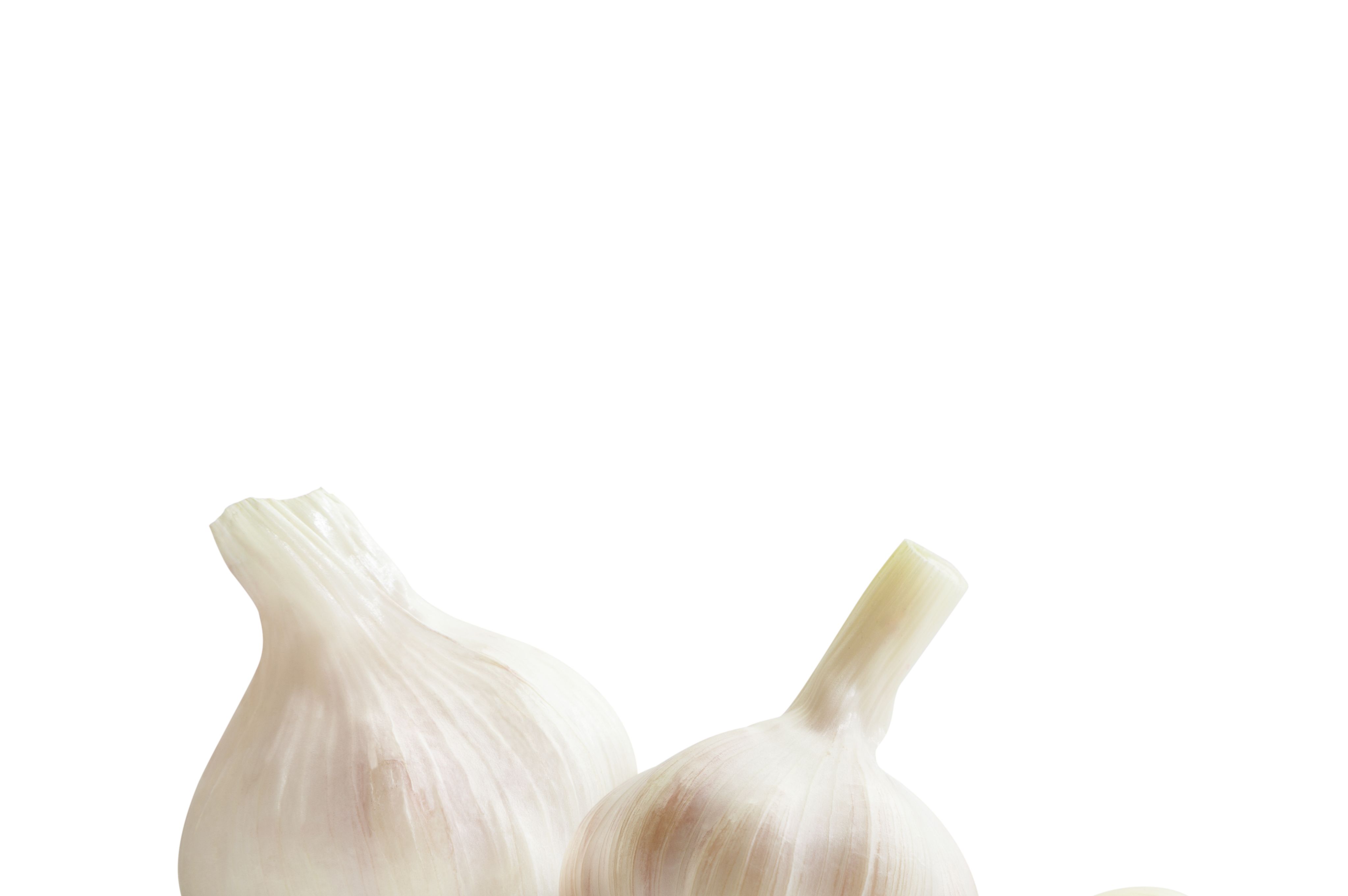 Close-Up Of Garlic Bulbs Against White Background