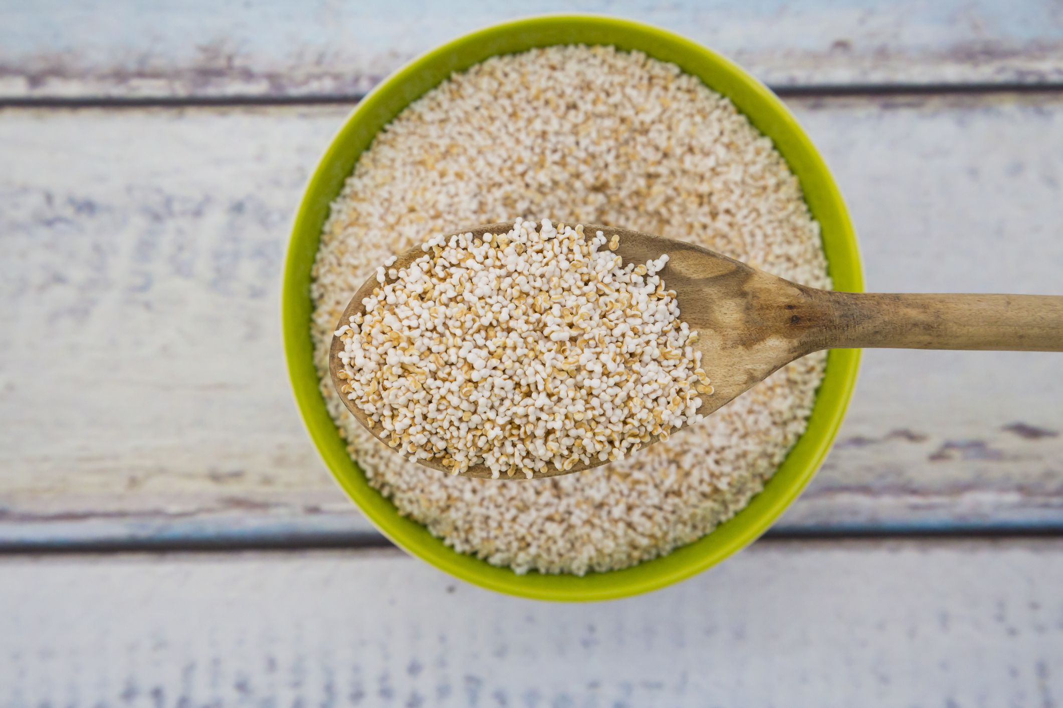 Popped organic amaranth on wood spoon and in bowl