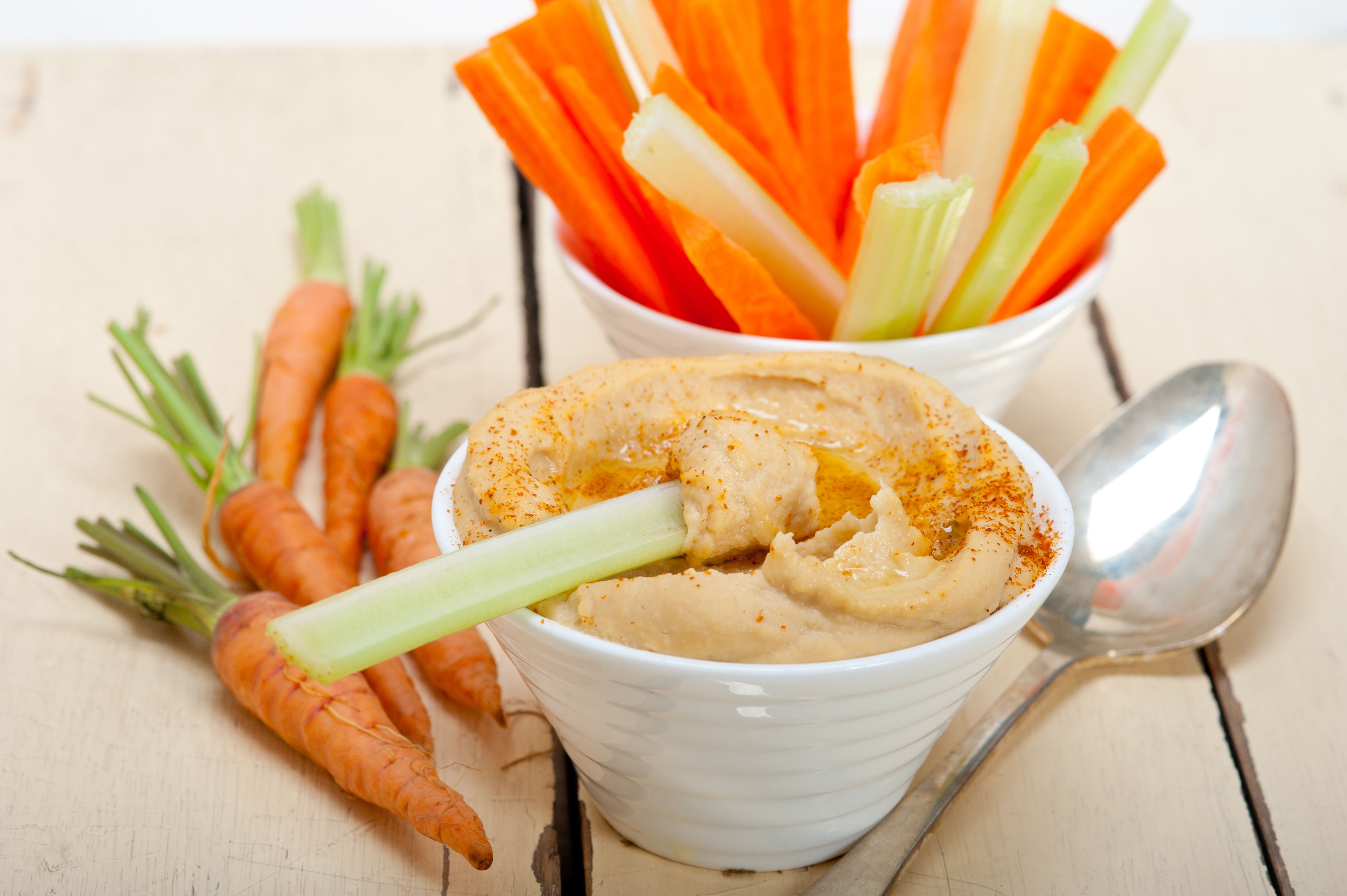 High Angle View Of Hummus And Carrots On Table