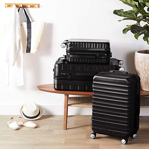 AmazonBasics - Maleta rígida giratoria prémium de 55 cm, negra
