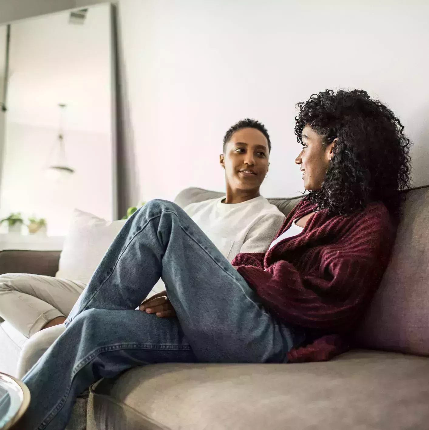 lesbian couple at home relaxing on couch