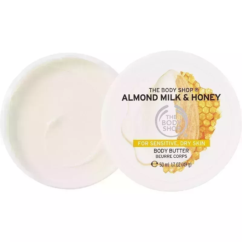 The Body Shop Almond Milk Body Butter jar open on white background