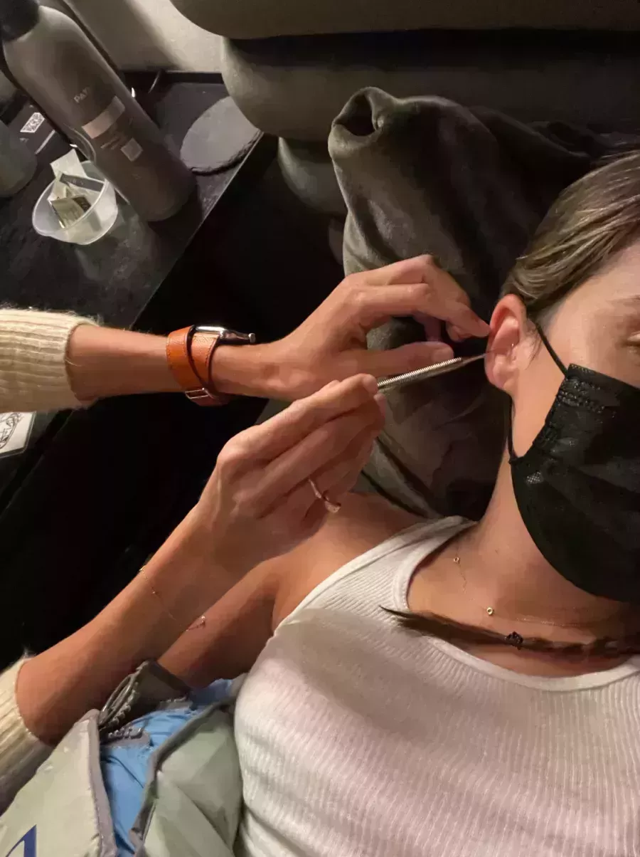 woman getting ear seen put in ear