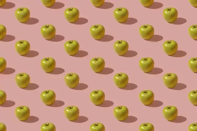 pattern of green apples against pink background