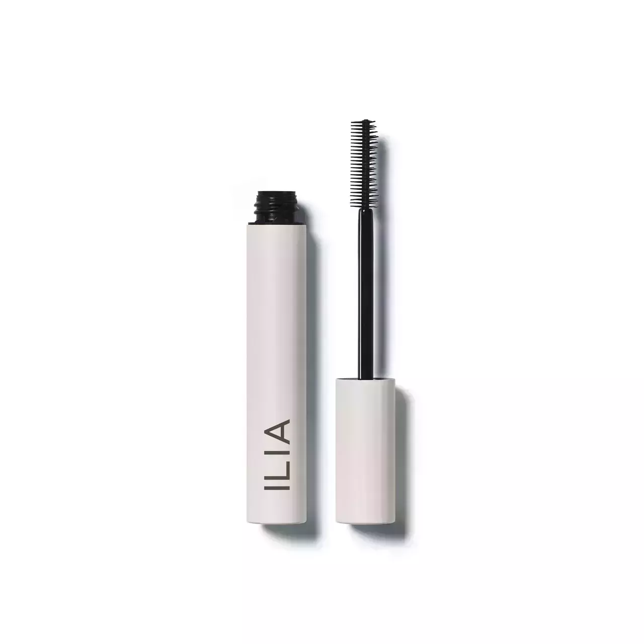 Ilia Limitless Lash Mascara open tube with mascara wand on white background