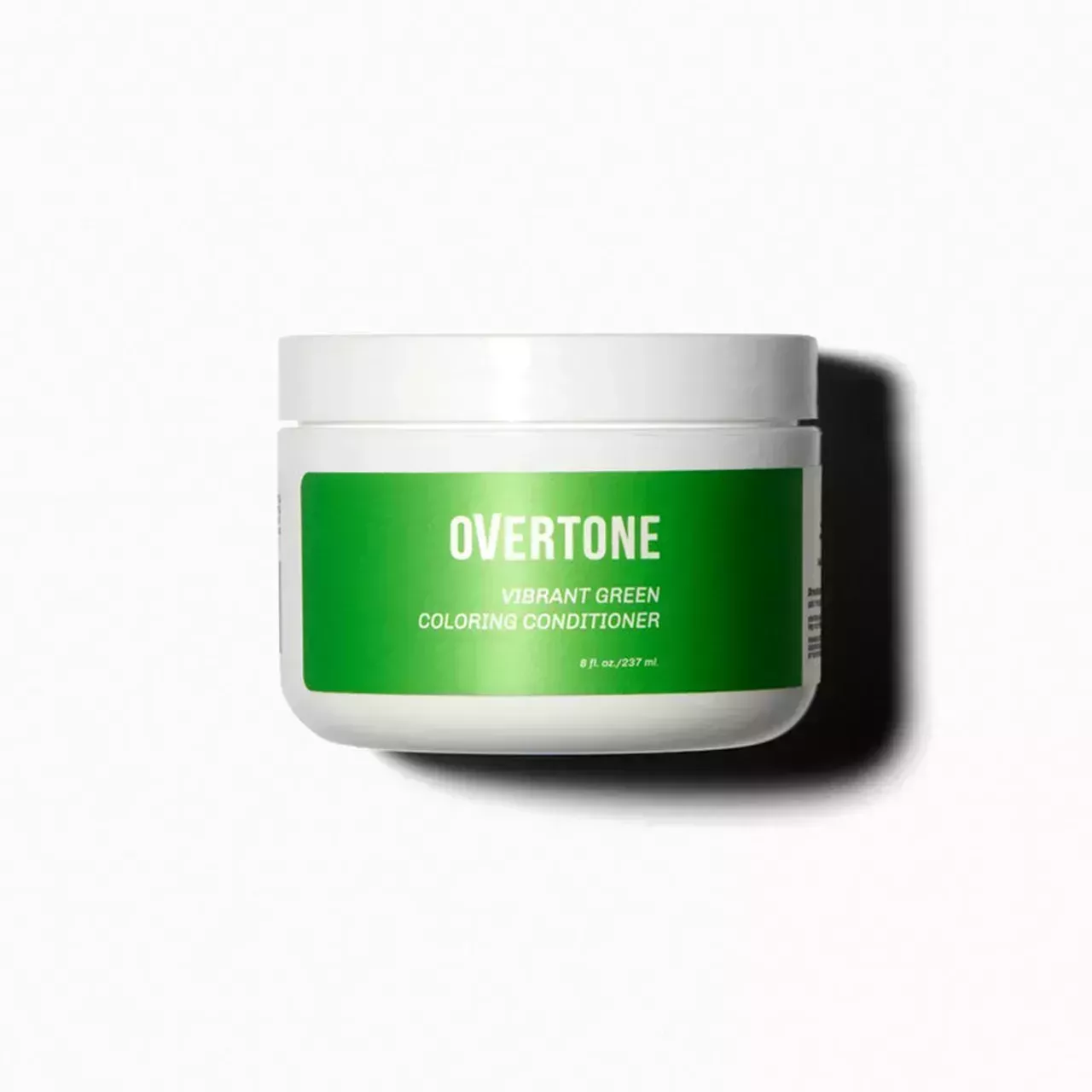 tub of Overtone Vibrant Green Coloring Conditioner on white background