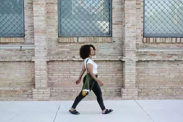 young curvy afro woman walking in the city copy space for text