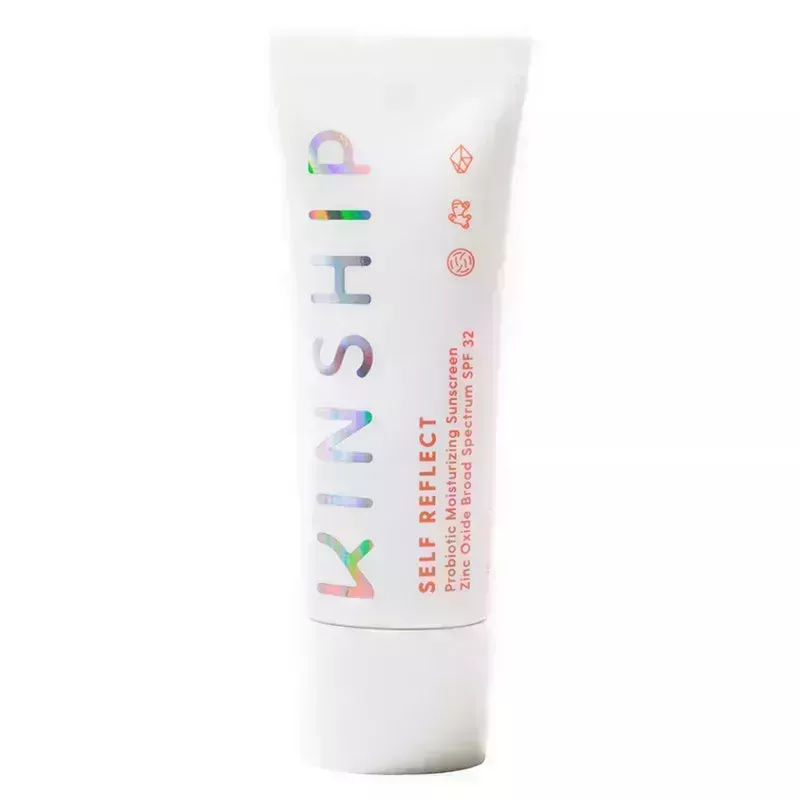 A white bottle of the Kinship Self Reflect Probiotic Moisturizing Sunscreen SPF 32 on a white background