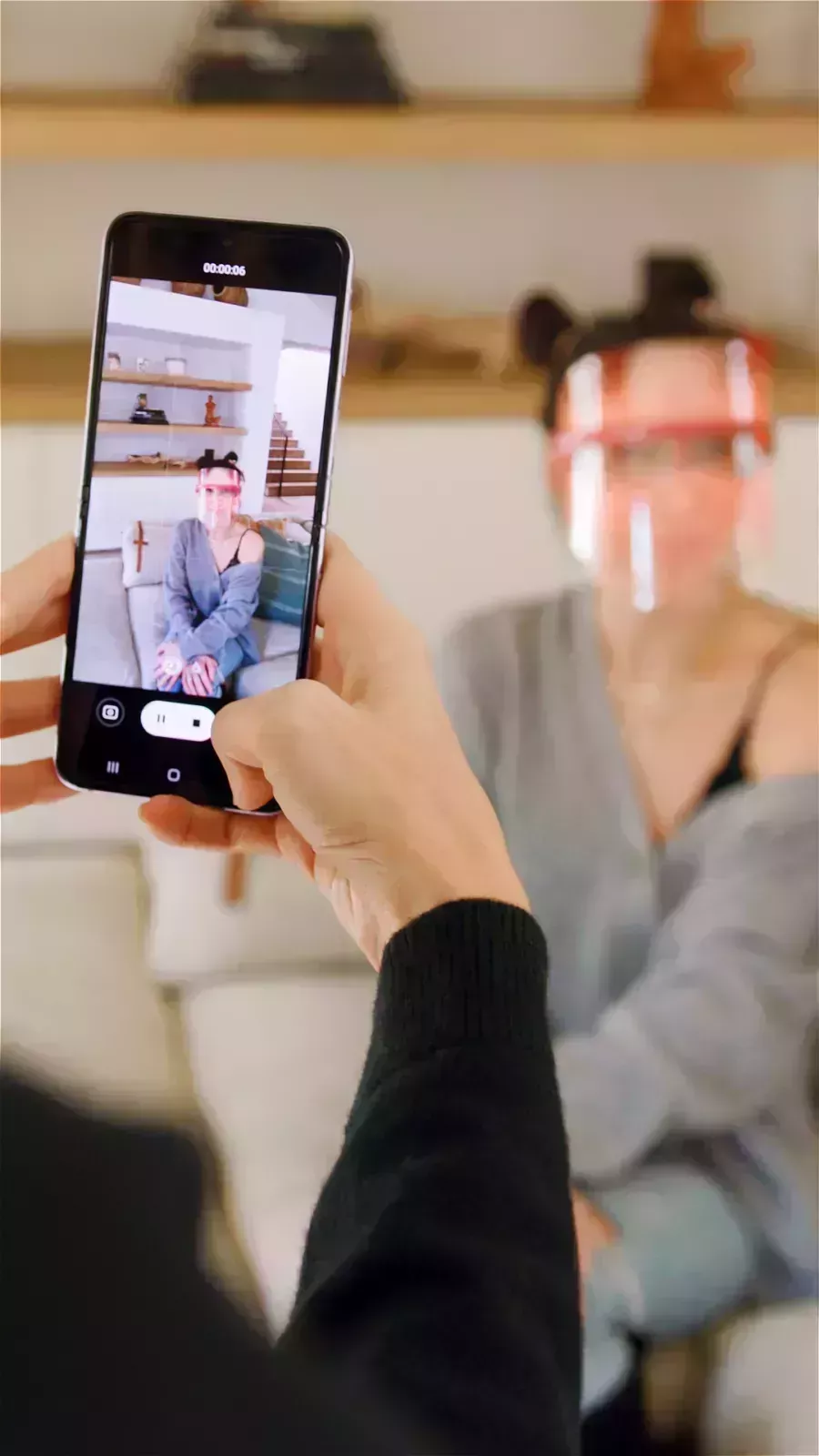 samsung phone capturing photo of sam hyatt wearing LED mask