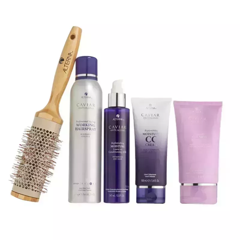 A photo of the Alterna Caviar Transform Your Blowouts Set, including a round bristle brush and four purple-hued products from the brand, on a white background
