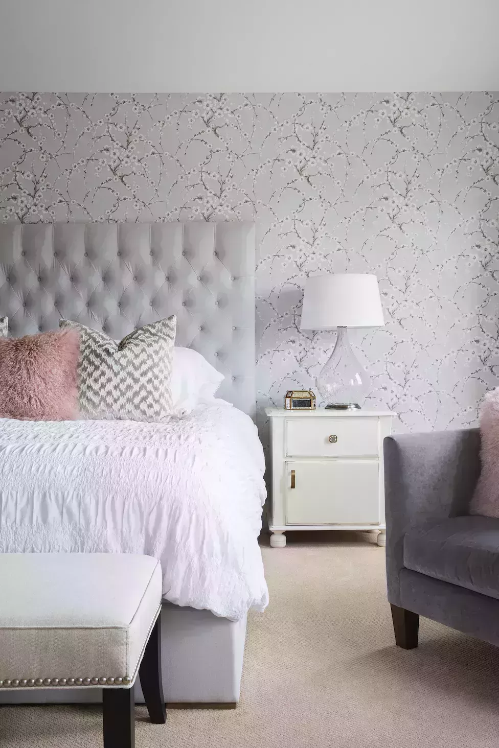 pink and gray bedroom, light gray floral wallpaper with fuzzy pink bed pillows
