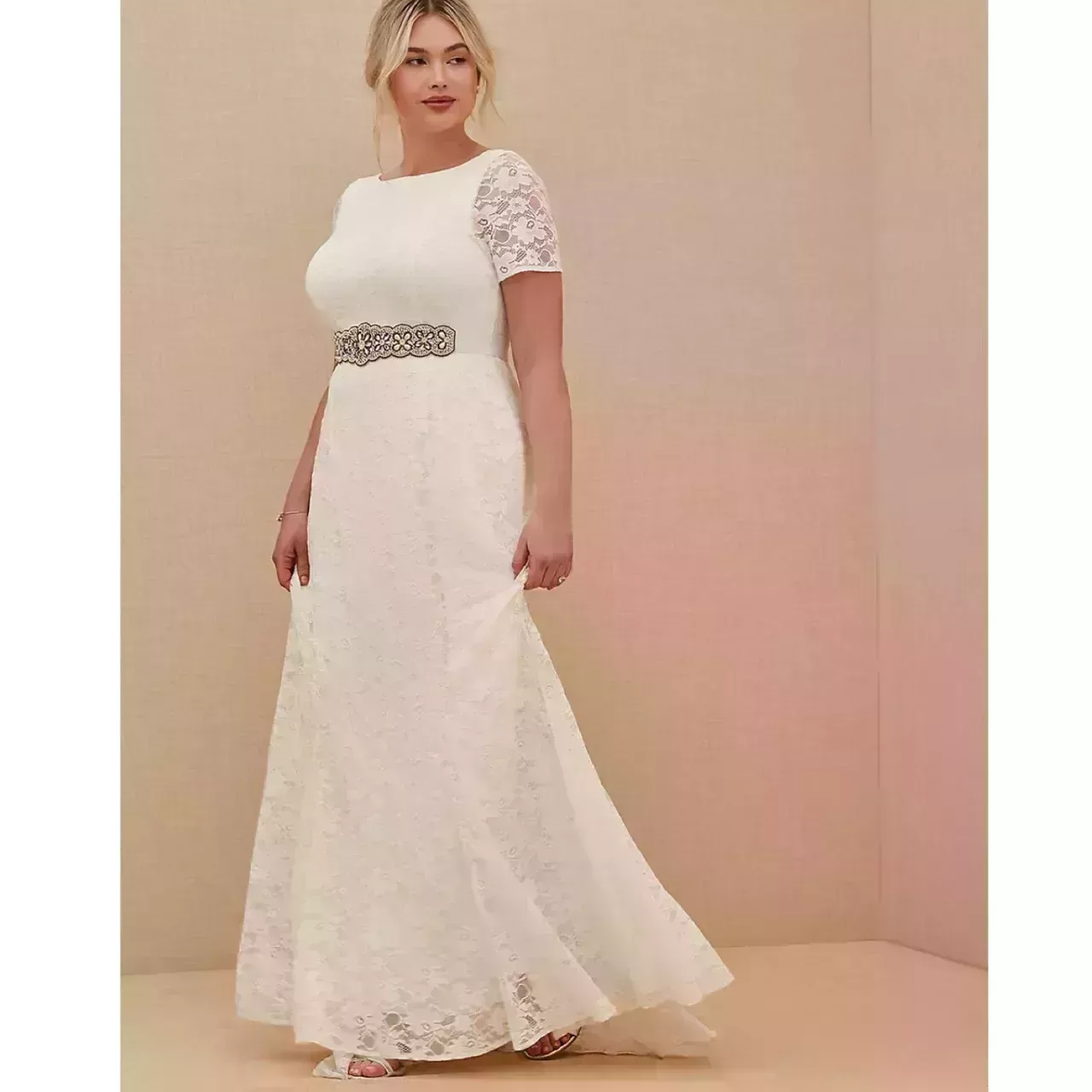 Model wearing Torrid Ivory Lace Short Sleeve Fit & Flare Wedding Dress