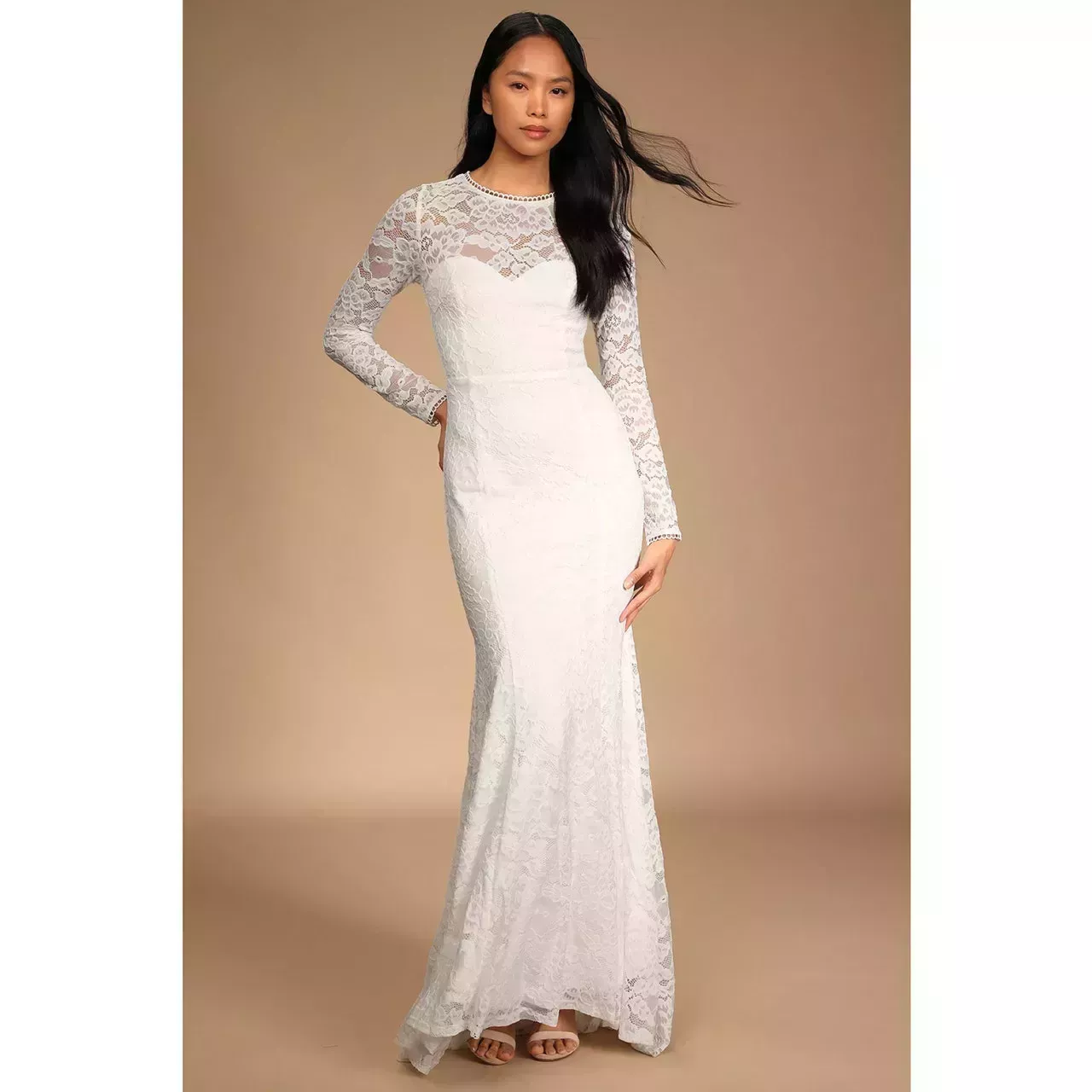 Model wearing Lulus Timeless Grace White Lace Backless Mermaid Maxi Dress