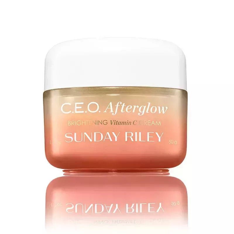 An orange jar of the Sunday Riley CEO Afterglow Brightening Vitamin C Cream on a white background