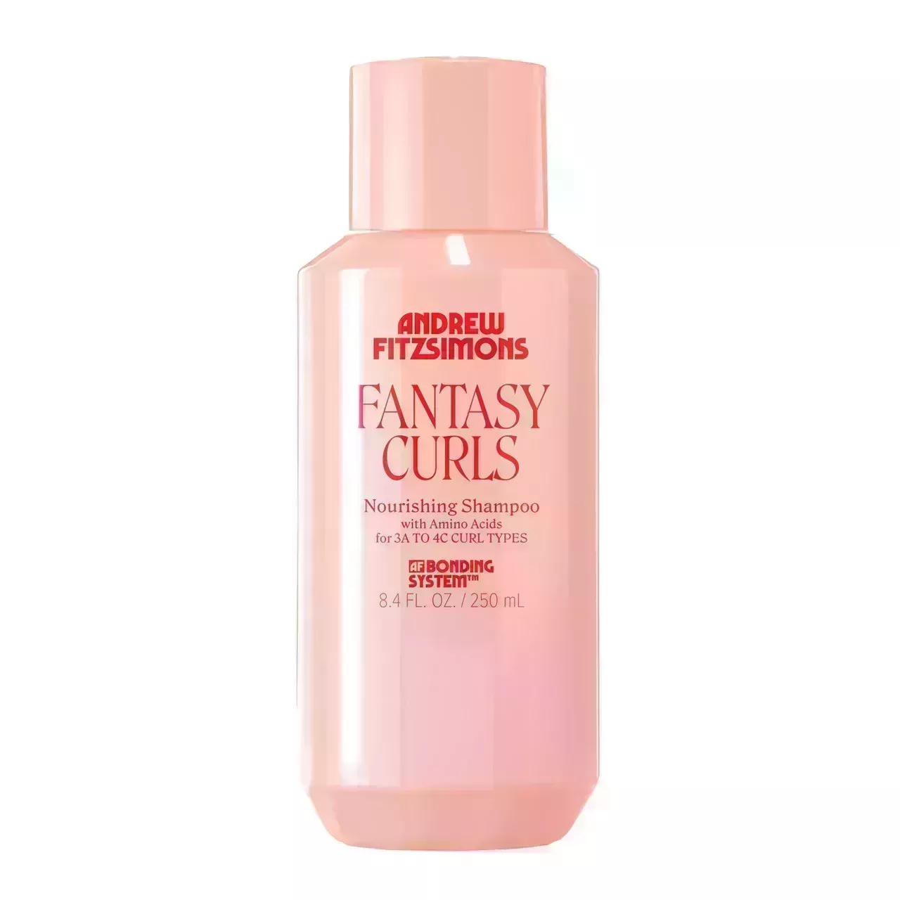 pink bottle of Andrew Fitzsimons Fantasy Curls Nourishing Shampoo with red lettering on a white background