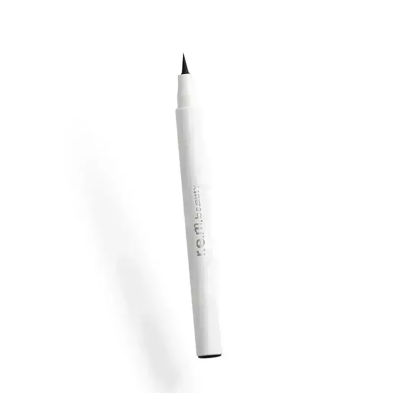 A white eye liner pen with a black felt tapered tip on a white background