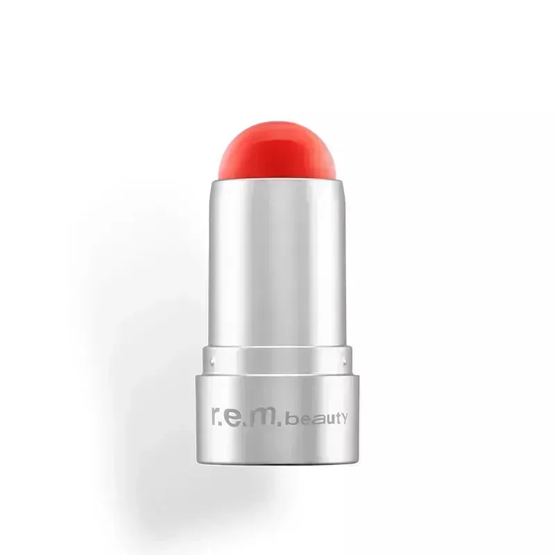A small silver tube of the r.e.m. beauty Eclipse Lip & Cheek Stick in bright red shade Leading Lady