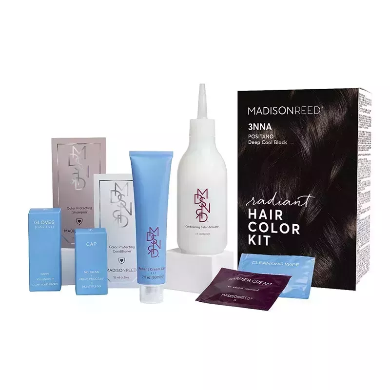 Four light blue, white, and silver boxes along with a light blue tube and white bottle, all from the Madison Reed Radiant Hair Color Kit, on a white background