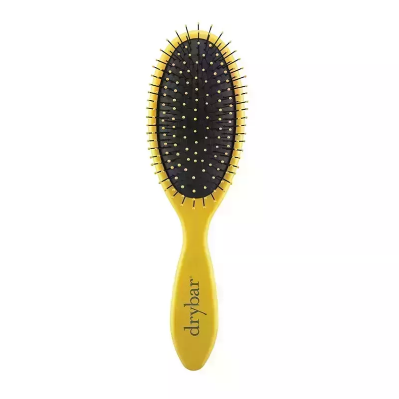 A yellow and black Drybar The Super Lemon Drop Daily Detangler round paddle brush on a white background
