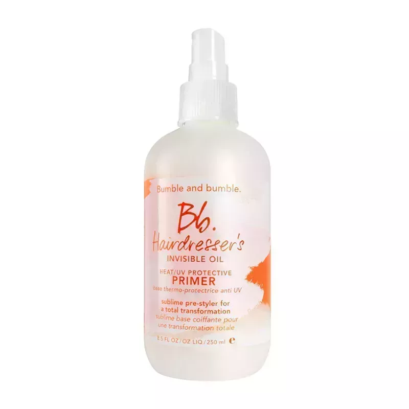 A white and orange spray bottle of the Bumble and bumble Hairdresser's Invisible Oil Heat/UV Protective Primer on a white background.