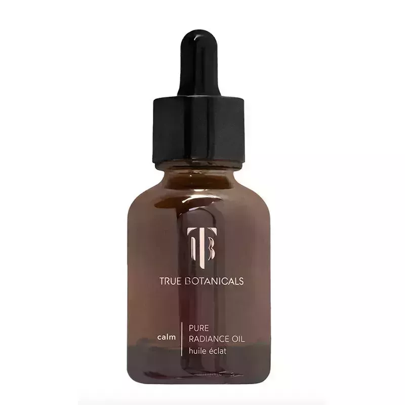 A brown vial of the True Botanicals Calm Pure Radiance Oil on a white background