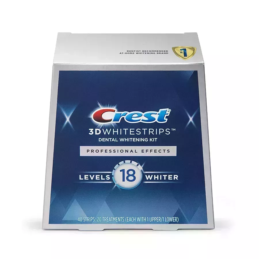 Crest 3D White Professional Effects Whitestrips blue and gray trapezoid shaped box of teeth whitening strips on white background