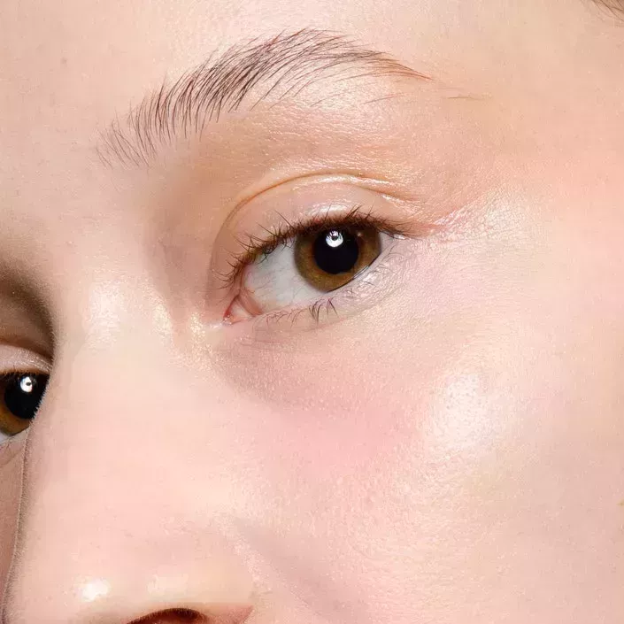 Close-up of a person's bare face. They have very clean skin