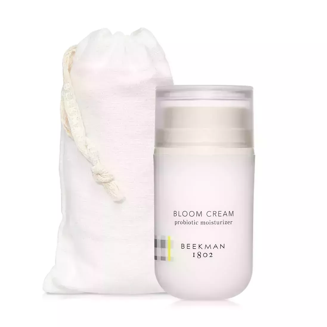 A white bag and jar of Beekman 1802 Bloom Cream Daily Moisturizer