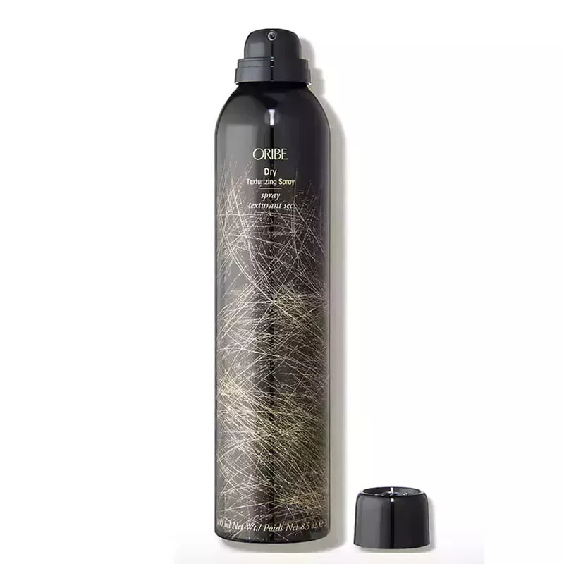 A black aerosol hairspray can of the Oribe Dry Texturizing Spray on a white background