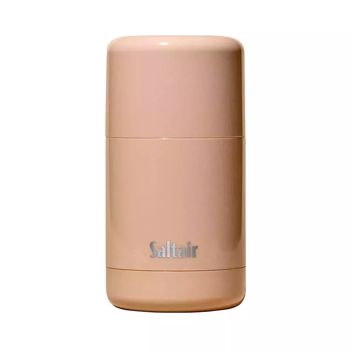 A peachy colored bottle of deodorant 