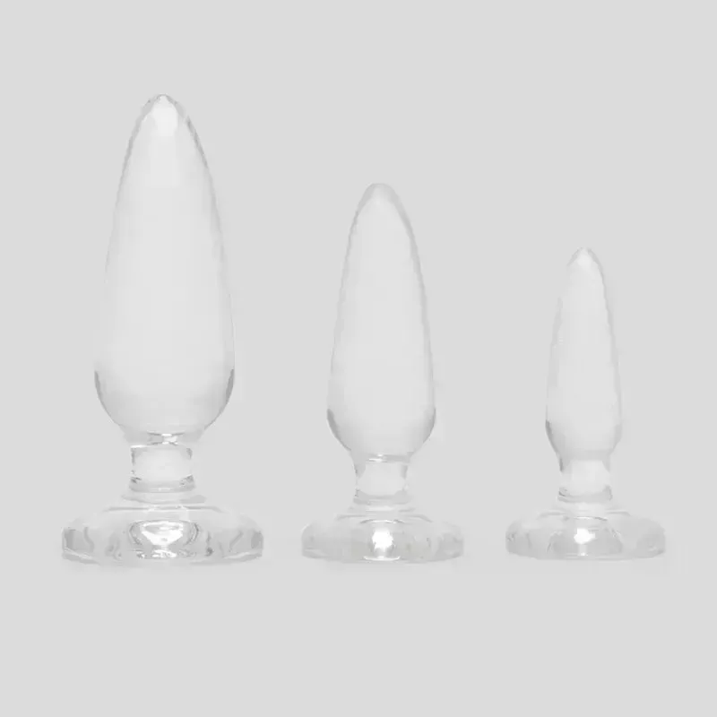 A three-piece set of the Jelly Rancher Pleasure Anal Training Butt Plug Kit on a gray background