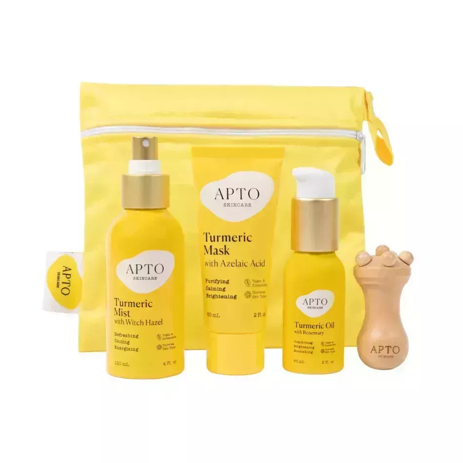 Apto Skincare Turmeric Glow Bundle yellow skincare products and cosmetic bag on white background
