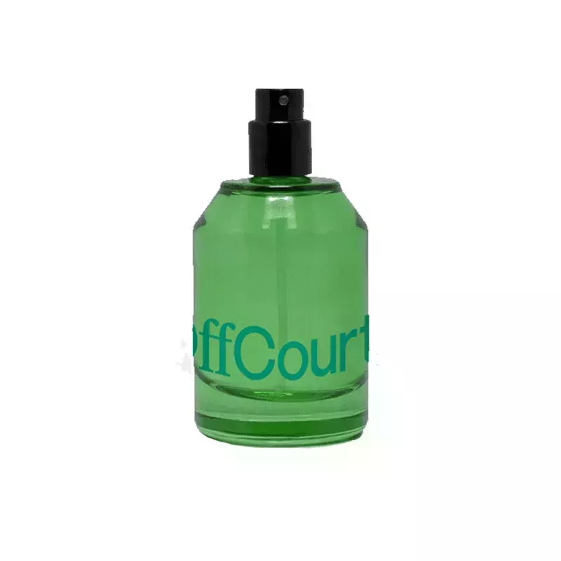 A green perfume bottle of the OffCourt Fig Leaves + White Musk Eau de Toilette on a white background