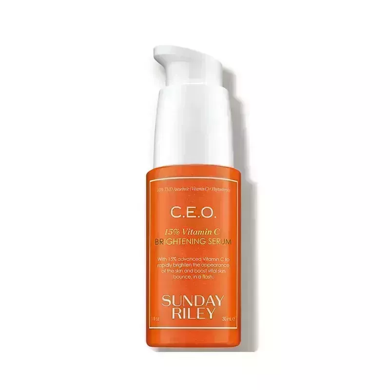 An orange pump bottle of the Sunday Riley C.E.O. 15% Vitamin C Brightening Serum on a white background