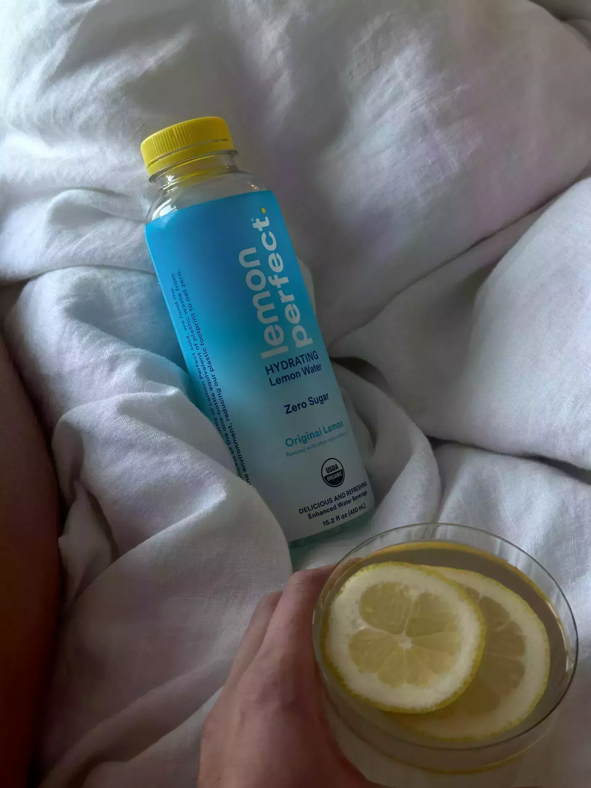 Lemon Perfect bottle on bed