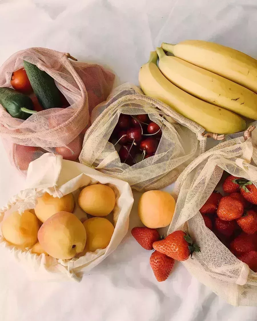overhead shot of cloth bags of fruit