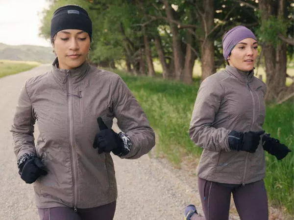 Dos modelos corriendo con ropa de correr Janji.