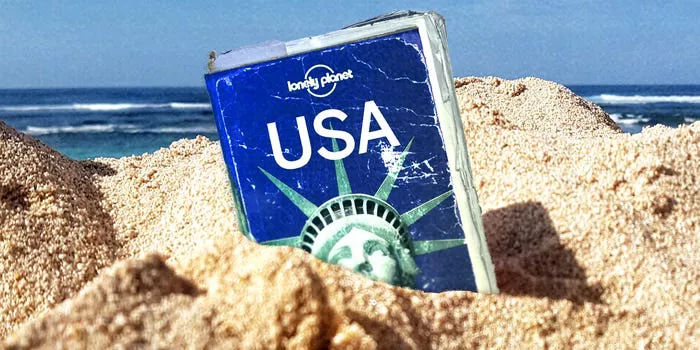 Lonely Planet book in sand.